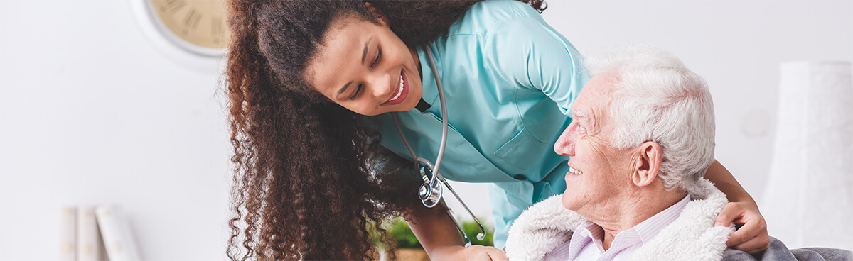 CNA nurse caring for elderly man